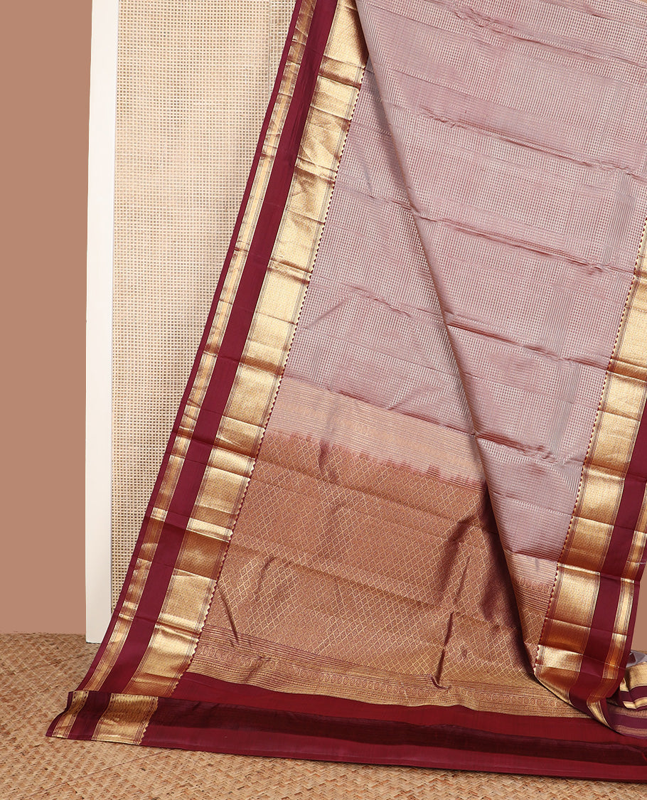 Brown micro-checked silk saree, contrast rettai pettu border of thazampoo rekku, banaras, muthu, and geometric designs, and jaal pallu