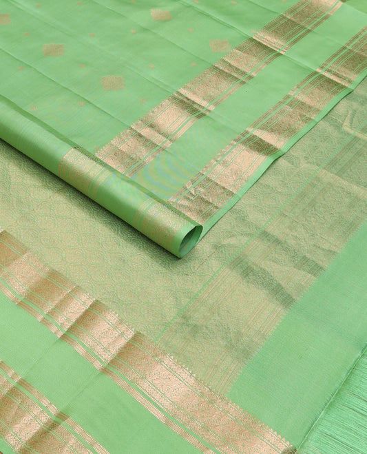 Pista green zari buttas silksaree, ogee patterned pallu & rettai pettu zari border of rekku,muthu,banaras & kili motifs