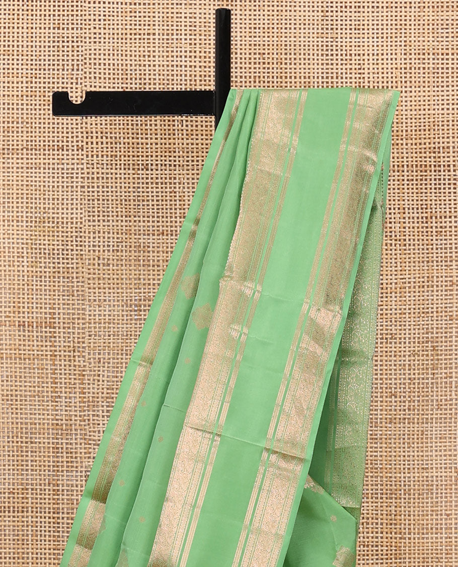 Pista green zari buttas silksaree, ogee patterned pallu & rettai pettu zari border of rekku,muthu,banaras & kili motifs