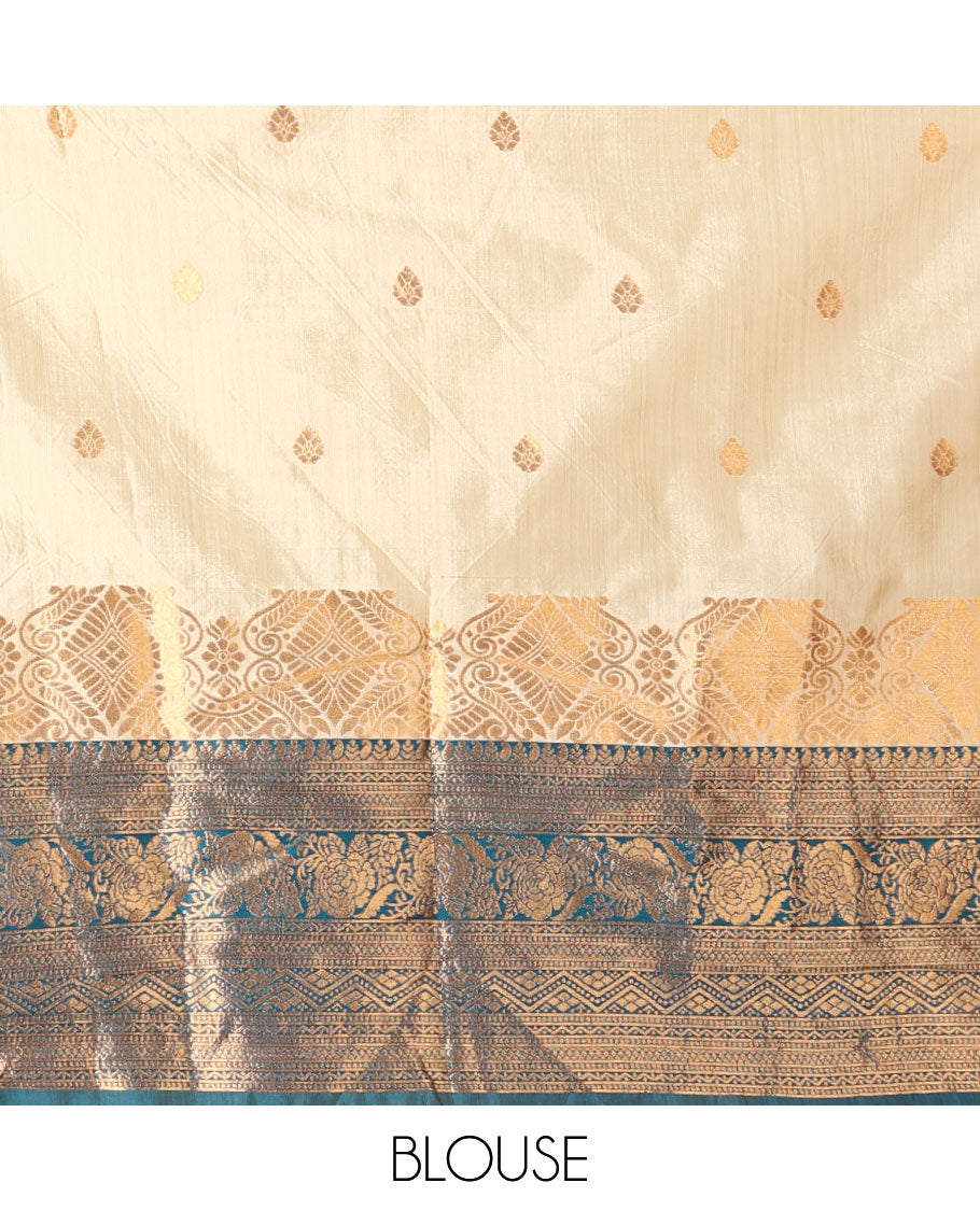 Cream-blue art-silk half-saree, zari buttas with contrast traditional design bordered skirt, a matching blouse, and scallop stone work dhavani