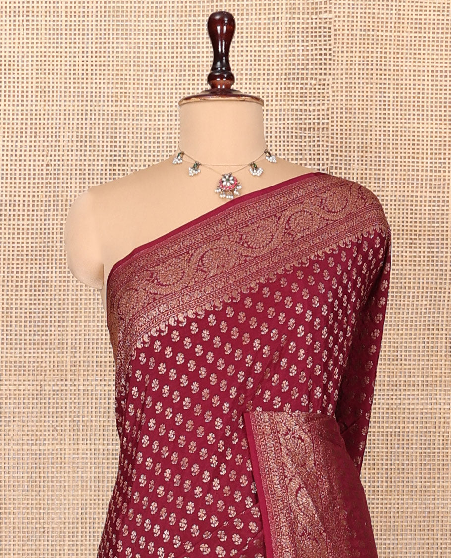Light Maroon Fancy Crepe Saree, Steeped with Buttas, Highlighted by a Floral Creeper Border, Intricately Designed Pallu, and a Matching Blouse