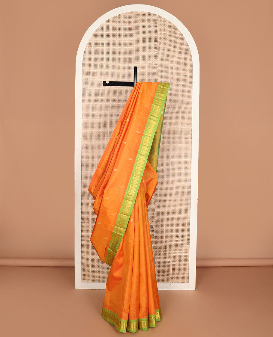 Kesari orange zari buttas kanchipuram silksaree, contrast one-sided border of paneer sombu,banaras & mayil kann & zari design pallu