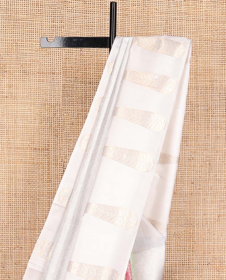 Cream and multi-color half-and-half ogee patterned Kanchipuram silk saree, zari border of big thilakam-shaped leaf buttas, and jaal pallu