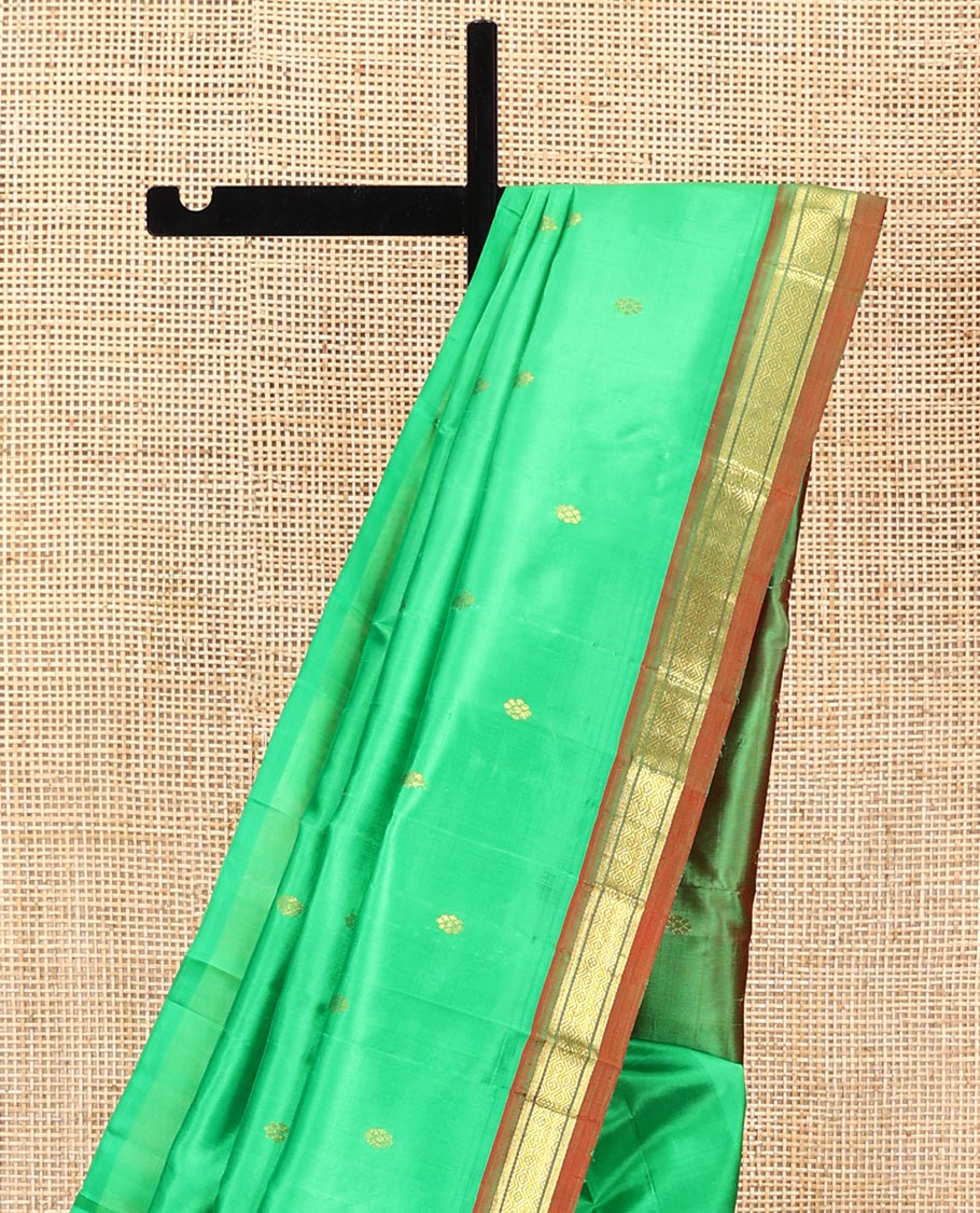 Green Kanchipuram Silk Saree, Embellished with Zari Buttas All Over Its Body, Complemented by a Contrast One-Sided Border of Banaras, and Jaal Designs, Pallu of Zari Designs, and Comes Without a Blouse