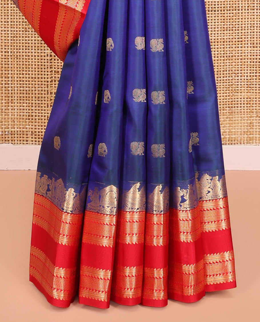 Blue Vasundhara Silk Saree, Dazzled with Mayil and Yaanai Buttas All Over Its Body, Complemented by Contrast Border of Wedding-Theme Motifs, Ara Bogudi, Muthu, and Ara Maadam Designs, Grand Jaal Pallu, and Paired with a Contrast Blouse