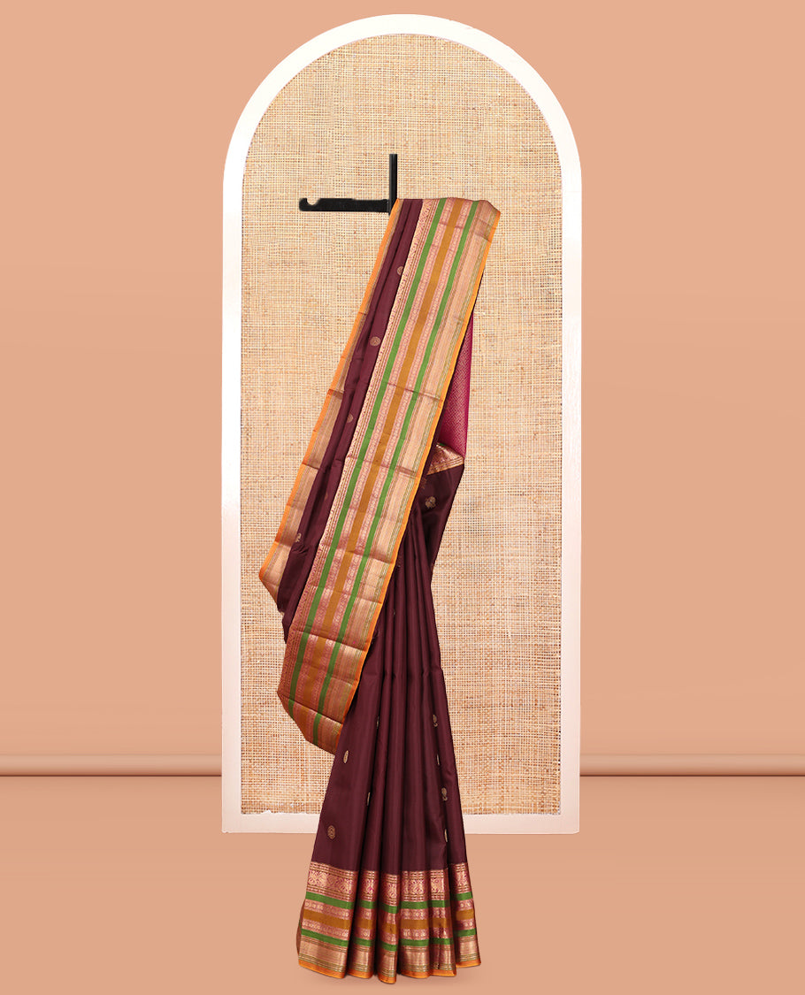 Brown Vasundhara Silk Saree, Delicately Woven with Mayil-Chakram Buttas, a Contrast Border of Kathir, Mayil, Yaanai, Muthu, Neli, and Laddu Kamalam Designs, a Grand Pallu, and a Contrast Blouse