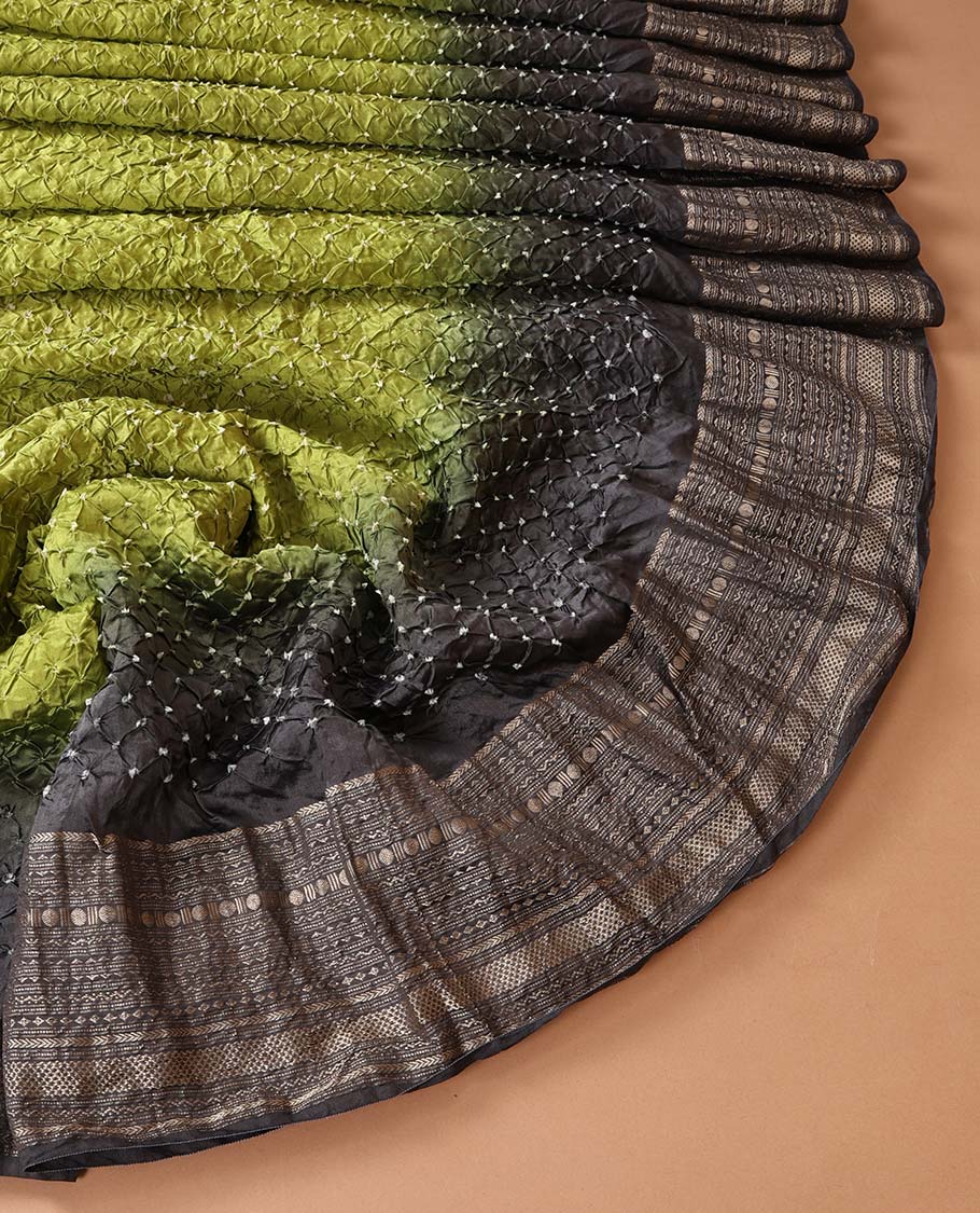 Green bandhani dotted bandhani silk saree, contrast traditional motifs steeped border, and zari striped pallu