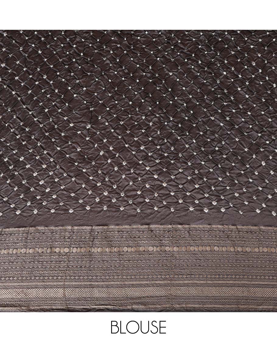 Green bandhani dotted bandhani silk saree, contrast traditional motifs steeped border, and zari striped pallu