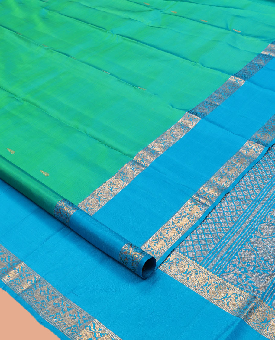 Green Kanchipuram Silk Saree, Ornamented with Zari Buttas, Complemented by Contrast Rettai Pettu Border of Rekku, Muthu, and Mayil Designs, Jaal Pallu, and Contrast Blouse
