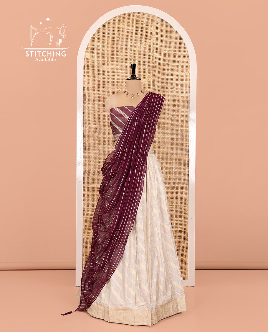 Cream-Purple Semi-Banarasi Half-Saree Features Leheriya Striped Skirt, Contrast Leheriya Striped Blouse, Georgette Striped Dhavani