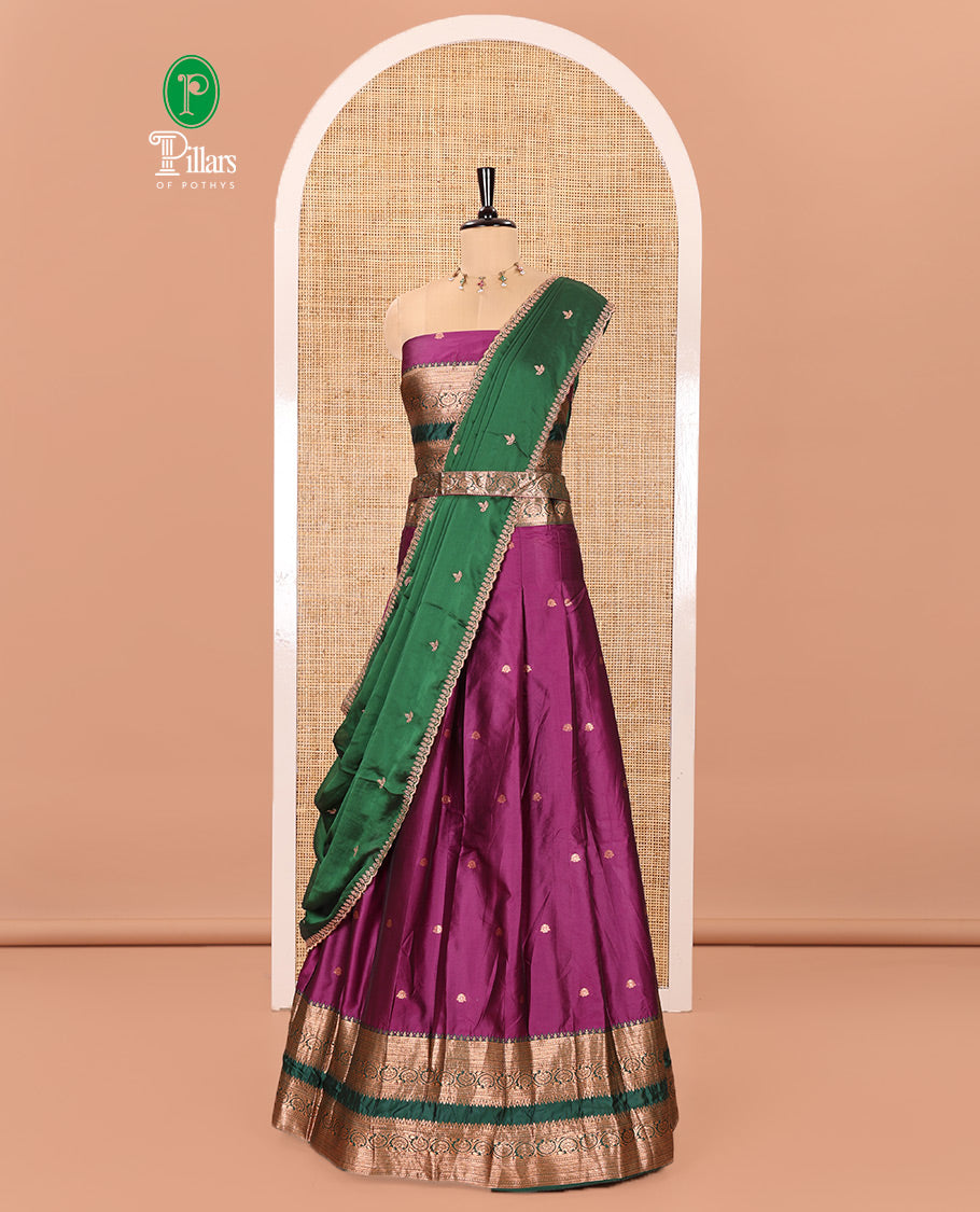 Purple and Green Semi-Banarasi Half-Saree Featuring Zari Buttas Skirt, Complemented by Contrast Rettai Pettu, Traditional Border of Floral Creeper Designs, Paired with a Matching Blouse, and a Satin Georgette Embroidered Scallop Dhavani