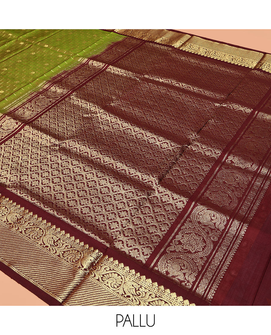 Green Venkatagiri Silk Saree, Delicately Woven with Zari Butta and Chevron Stripes All Over Its Body, Complemented by a Contrast Traditional Zari Border, Pallu of Ogee Designs, and Paired with a Contrast Blouse
