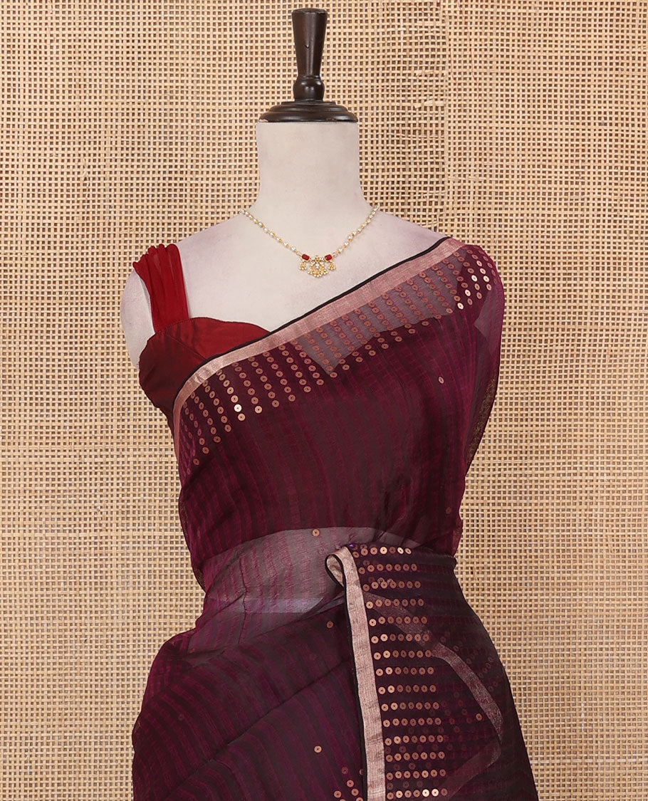Wine sparsely striped saree, gleaming zari border features polka dots, and pallu steeped with polka dots