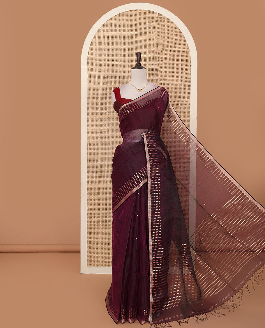Wine sparsely striped saree, gleaming zari border features polka dots, and pallu steeped with polka dots