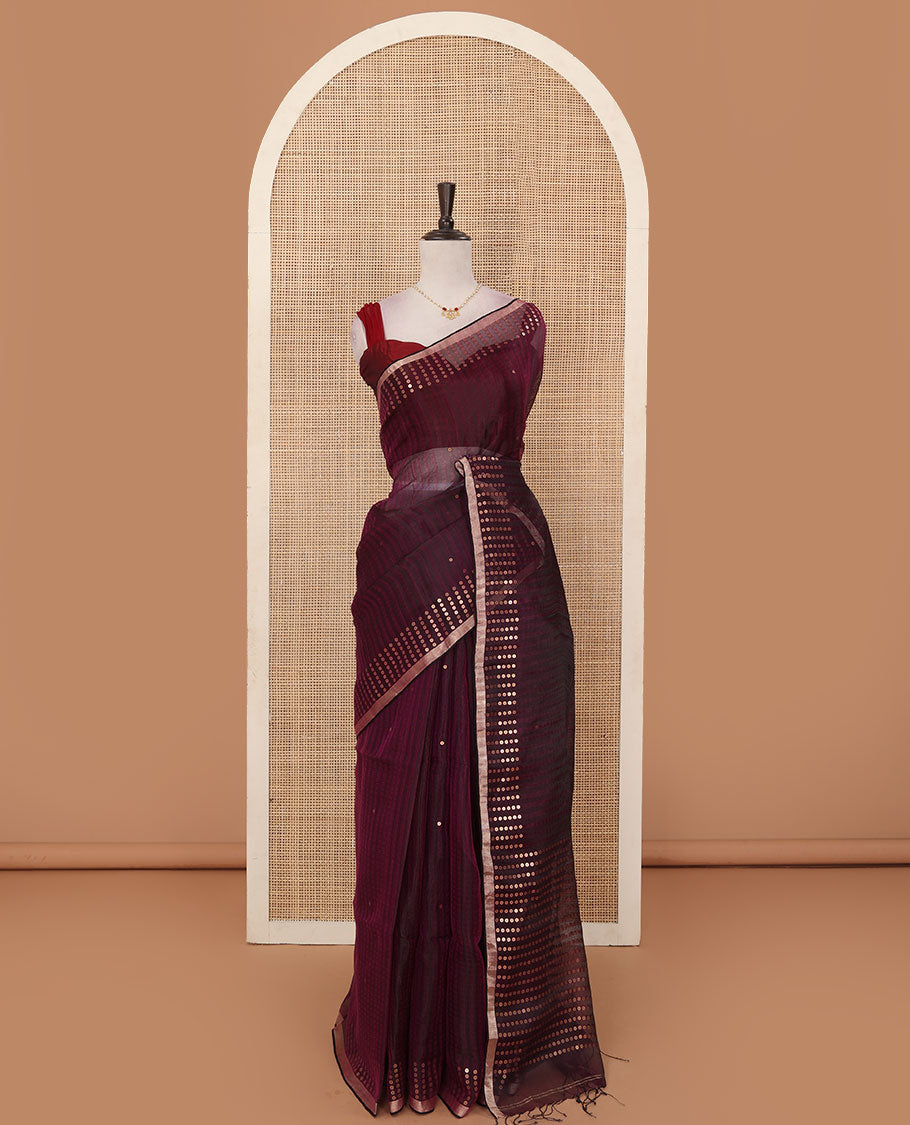 Wine sparsely striped saree, gleaming zari border features polka dots, and pallu steeped with polka dots