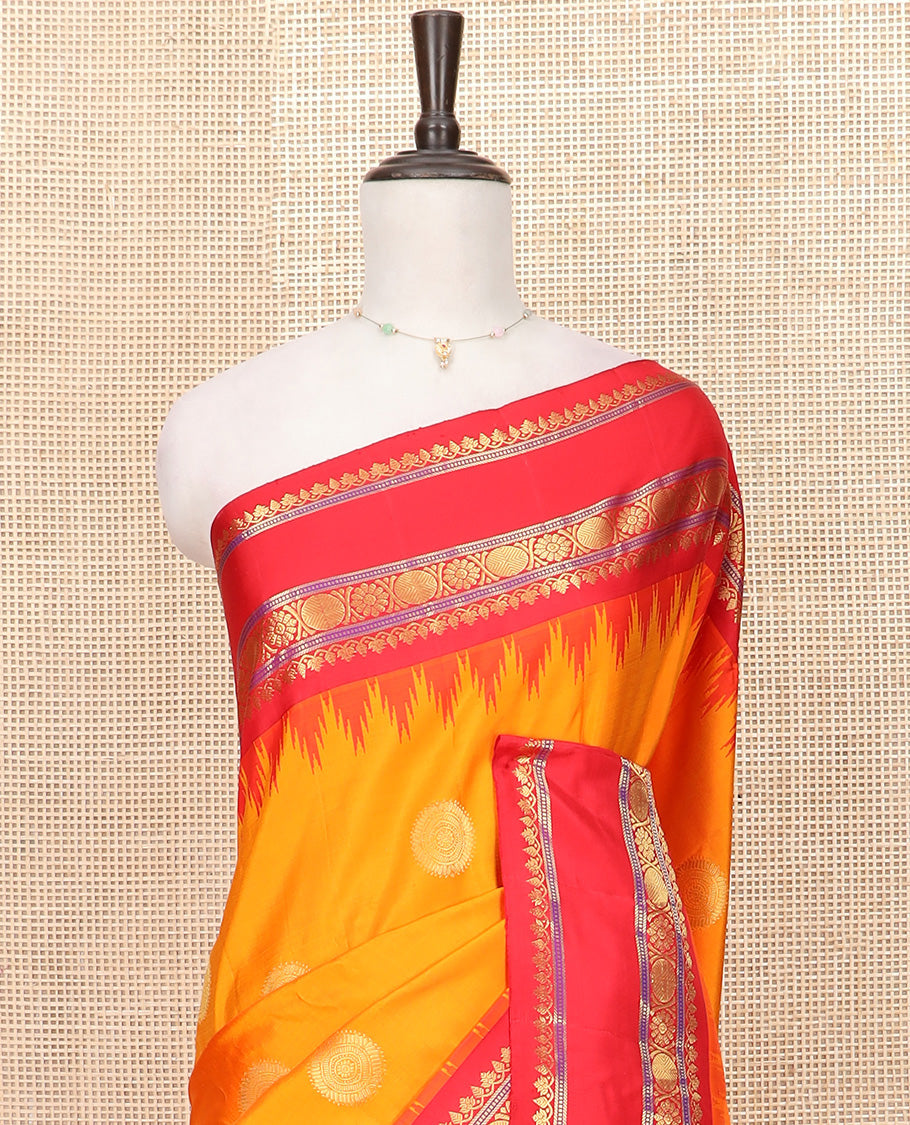 Orange Gadwal Saree Zari Accentuated with Chakra Buttas, Contrast Temple Border of Traditional Zari Designs, Pallu of Zari Designs, and a Contrast Blouse Complemented with Zari Designs