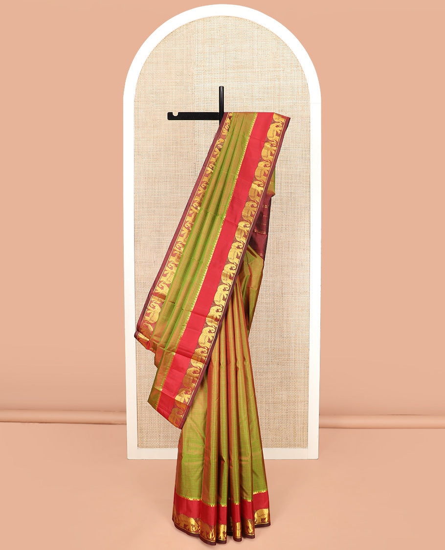 Green Dual-Toned Vazhaipoo Striped Kanchipuram Silk Saree, Complemented by Contrast Rettai Pettu Border of Thilakam Mokku, and Yaanai Designs, Pallu Subtly Woven in Stripes, and Paired with a Contrast Blouse