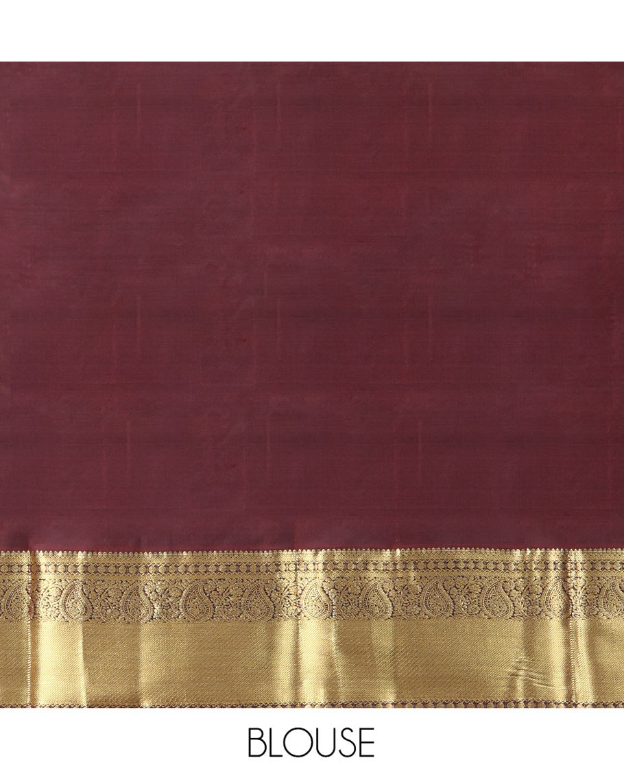 Brown Vasundhara Silk Saree Beautified with Zari Buttas All Over Its Body, Gleamed Up with a Zari Border of Thilakam Mokku, Kathir, Rudraksham, and Arumbu Manga Designs, Majestically Detailed Pallu of Jaal Designs, and Comes with a Matching Blouse
