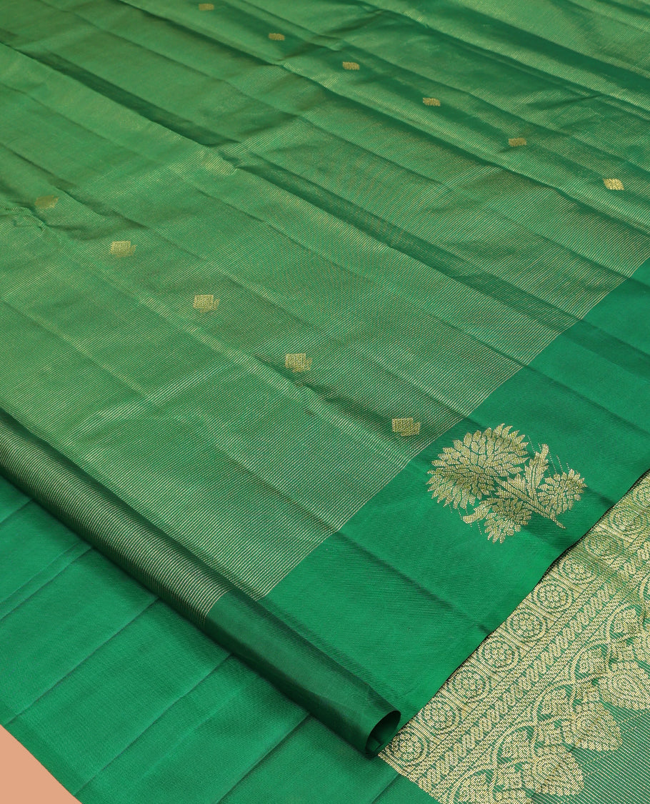 Green Kanchipuram Silk Saree, Woven with Zari Buttas and Stripes, Highlighted by a Zari Border of Floral Designs, Grand Jaal Pallu, and a Matching Blouse