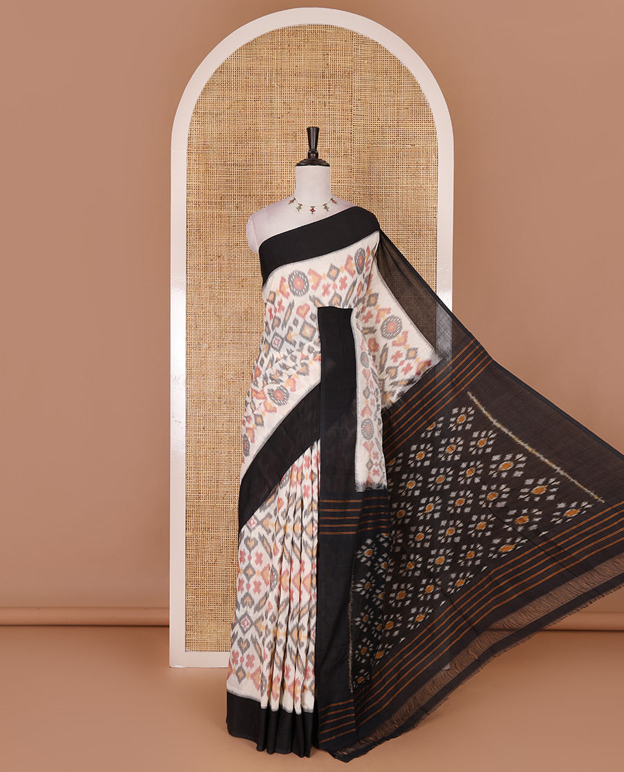 Half white intricate motifs featured ikkat cotton saree, contrast plain border, ikkat design pallu, and contrast plain blouse