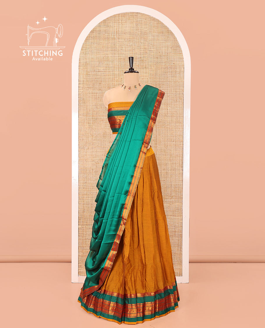 Mustard-Green Mercerised Cotton Half-Saree Features Plain with Contrast Traditional Zari Varisai Pettu Annam-Motif Bordered Skirt, Paired with a Matching Blouse, and Comes with a Contrast Zari-Bordered Dhavani