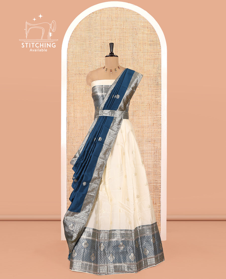 Cream-Peacock Blue Semi-Banarasi Half-Saree Set Featuring Buttas Skirt, Contrast Traditional Border, a Matching Blouse, and a Banaras Dhavani