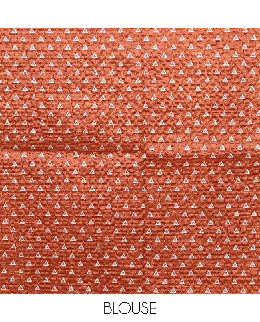 Rust batik-style warli printed Litch crushed saree, batik chevron border, floral-geometric printed pallu & triangle motif blouse