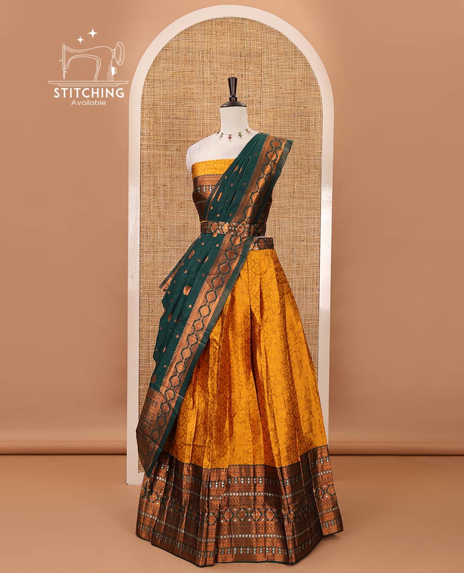 Mustard semi-banaras half-saree, embossed & contrast traditional zari border skirt,blouse of embossed & zari work & contrast green zari design dhavani