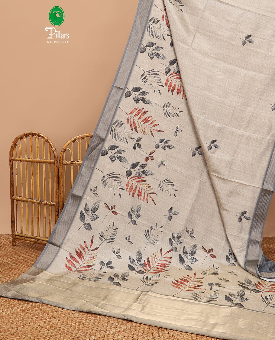 Cream leaf print tussar saree with tissue border & crush tissue pallu along with crush leaf print blouse