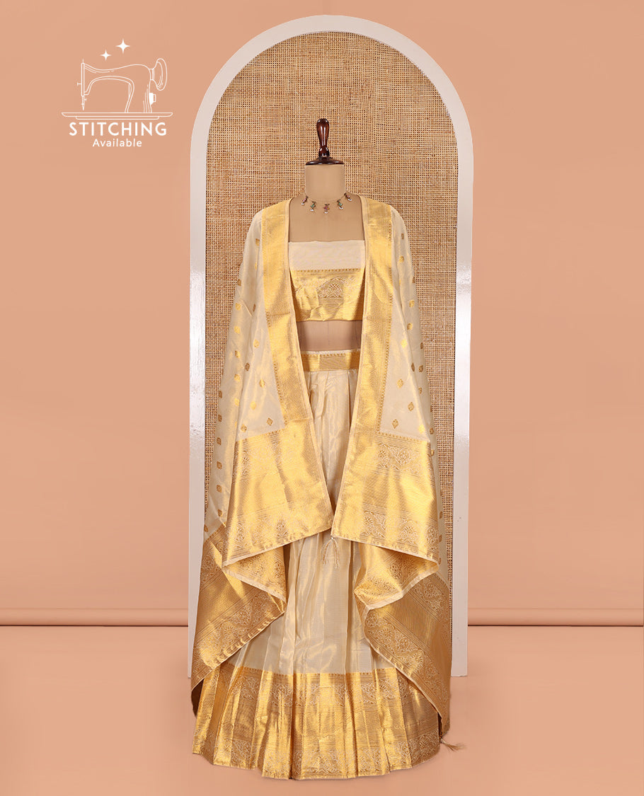 Cream Semi-Banarasi Tissue Half-Saree Features a Plain Skirt, a Traditional Border, Matching Blouse, and Intricate Dhavani