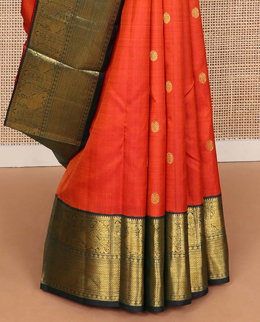 Orange chakram buttas Kanchipuram korvai silk saree, contrast neer korvai border of rekku, muthu, mayil, chakram, poun, and kuyil kann designs, and jaal pallu