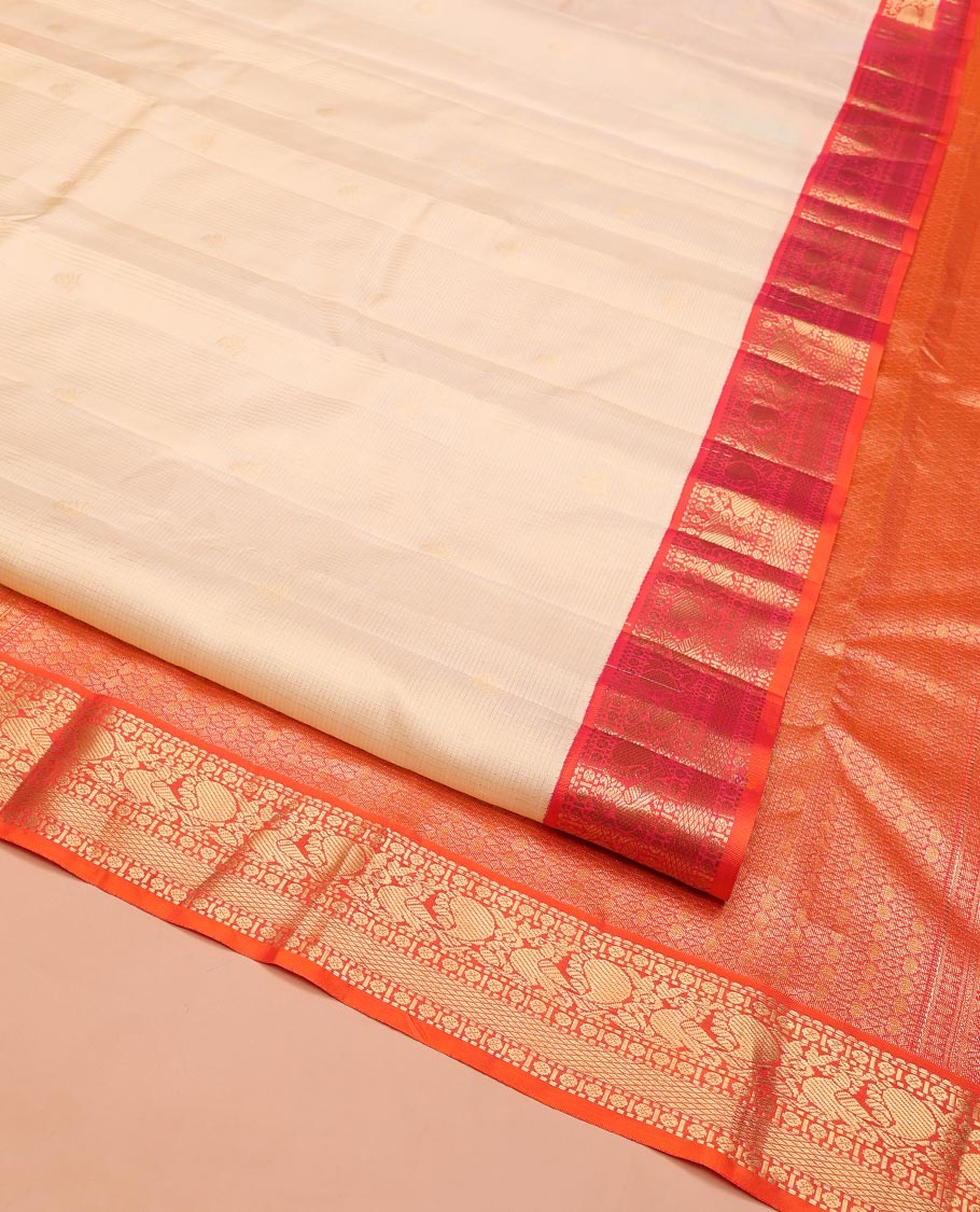 Sandal Vasundhara Silk Saree, Sparsely Woven with Zari Buttas on Its Body, Complemented by Contrast Border of Rudraksham, Mayil, Chakram, Muthu, and Mayil Kann Designs, Grandly Decked Up Pallu, and Paired with a Contrast Blouse
