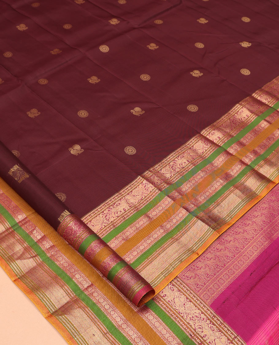 Brown Vasundhara Silk Saree, Delicately Woven with Mayil-Chakram Buttas, a Contrast Border of Kathir, Mayil, Yaanai, Muthu, Neli, and Laddu Kamalam Designs, a Grand Pallu, and a Contrast Blouse