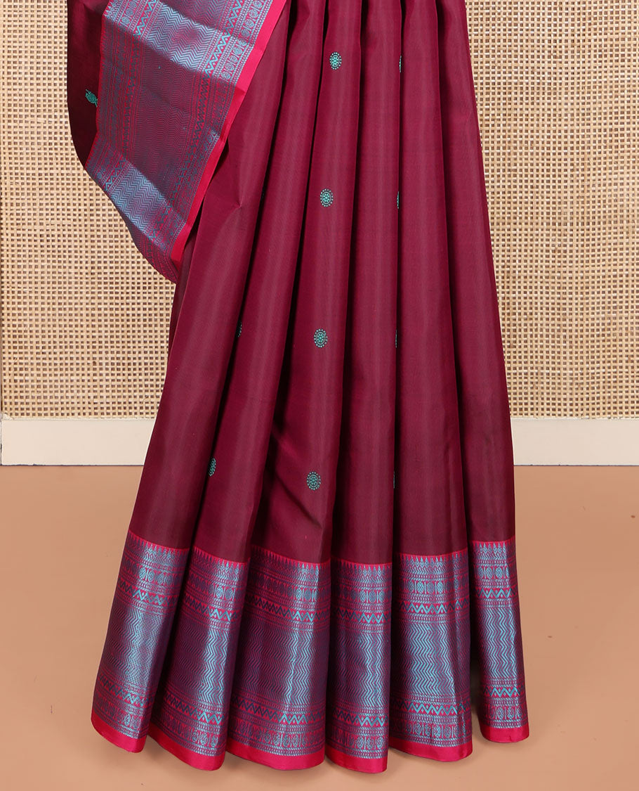 Wine Kanchipuram Silk Saree, Adorned with Mayil-Chakram Buttas All Over Its Body, Complemented by a Contrast Border of Thilakam, Banaras, Muthu, Rudraksham, Neli, and Vanki Designs, and Pallu Steeped with Kamalam Designs, and Paired with a Contrast Blouse