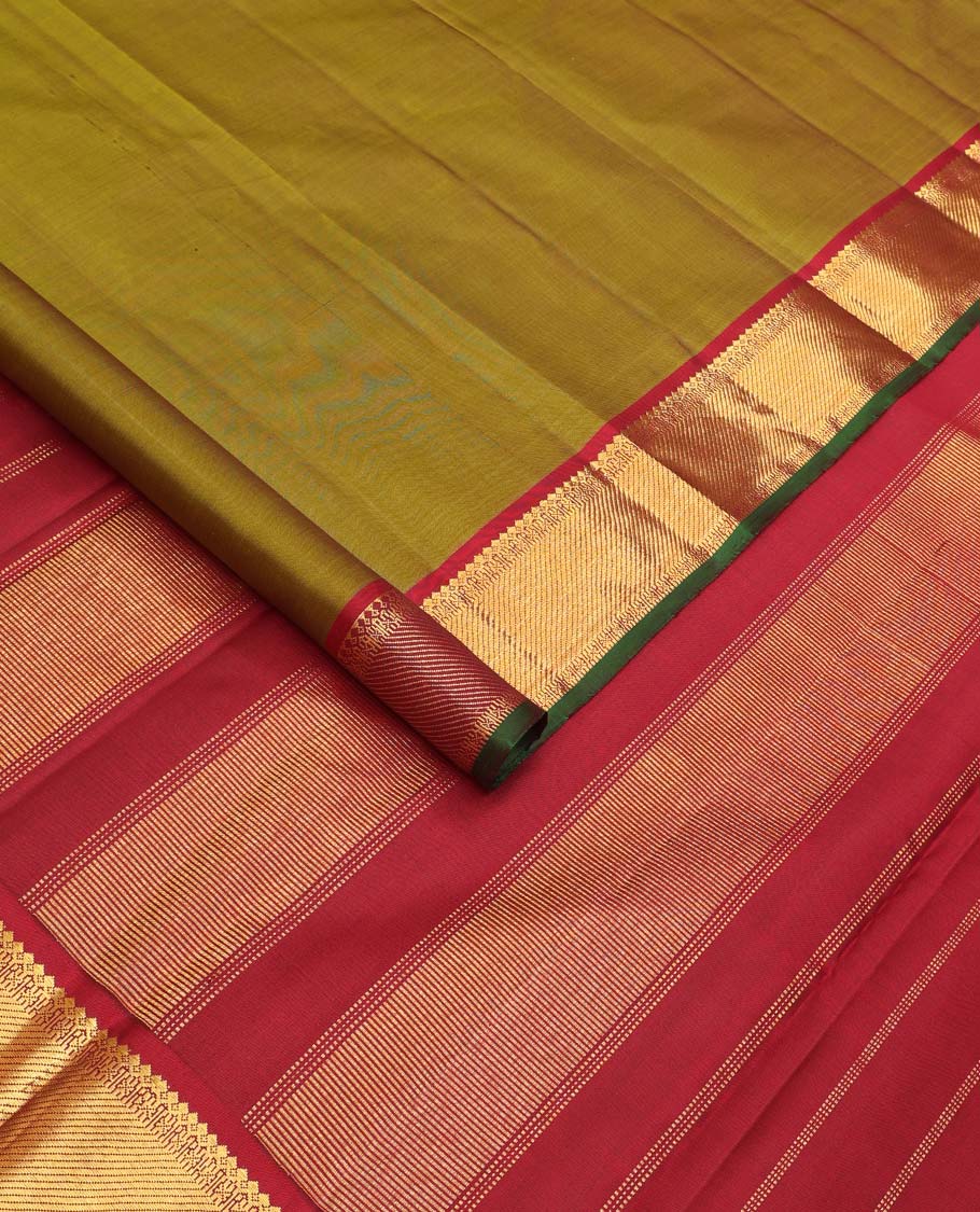 Green plain Kanchipuram silk saree, contrast border of thilakam mokku, muthu, cross kamalam, and zari stripes, and zari woven pallu