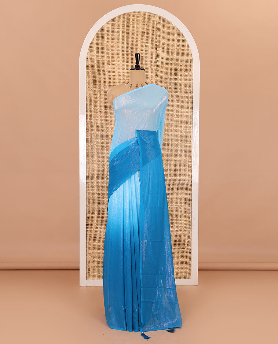 Borderless blue ombre-toned gleaming Shimmer Georgette saree, self-pallu with tassels and a plain blue blouse