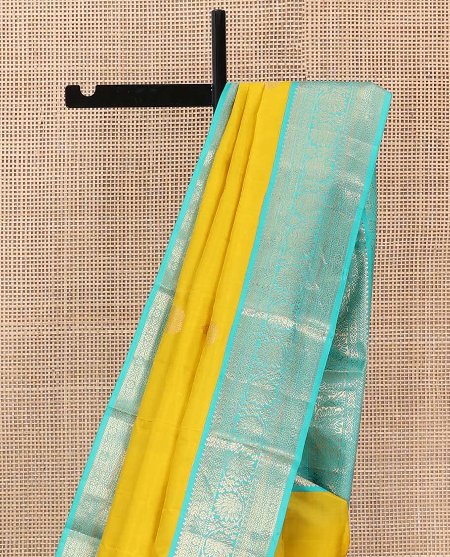 Yellow zari buttas silk saree, contrast border of jadai nagam, and mayil kann, and pallu of diagonally woven kodi manga and geometric designs