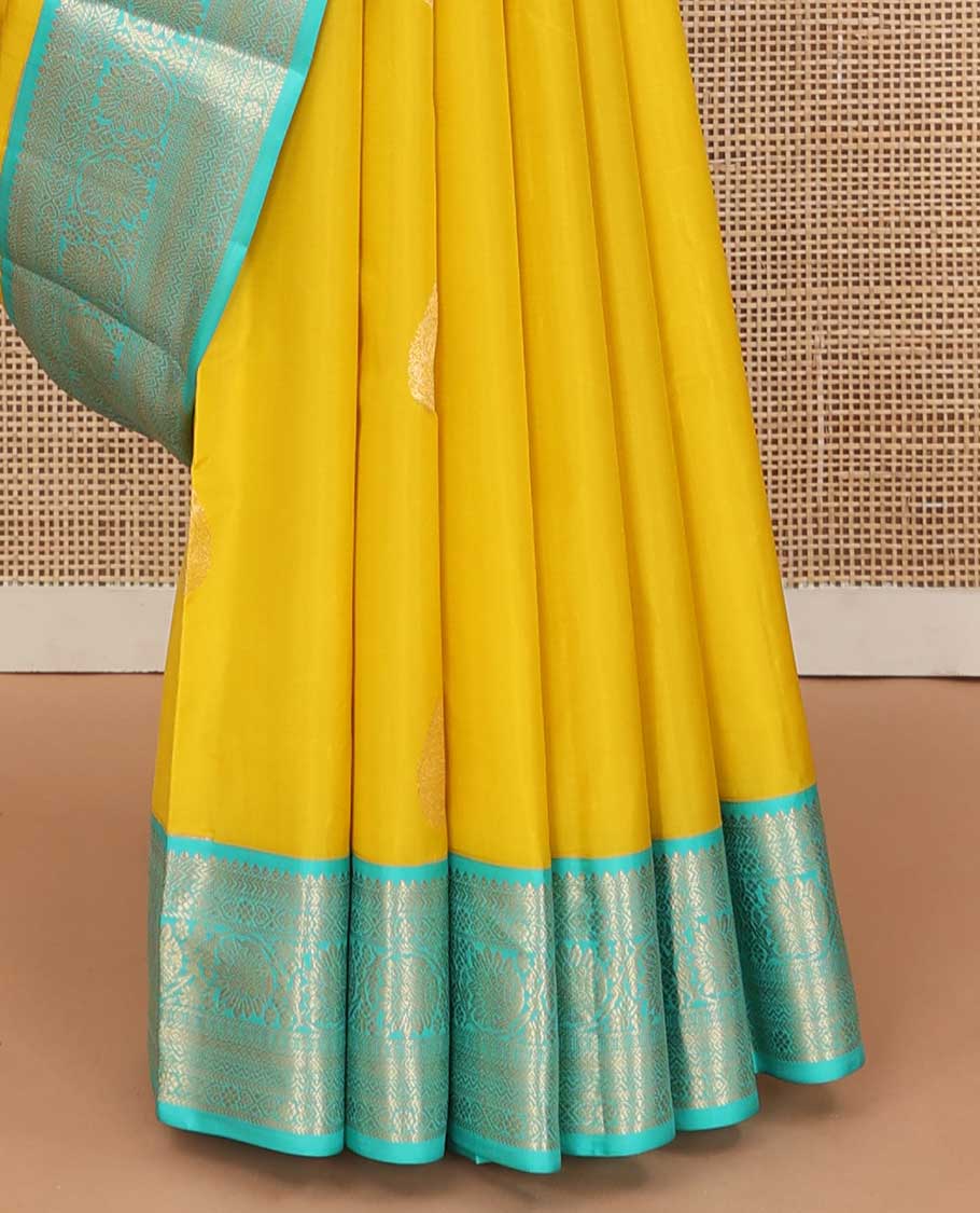 Yellow zari buttas silk saree, contrast border of jadai nagam, and mayil kann, and pallu of diagonally woven kodi manga and geometric designs