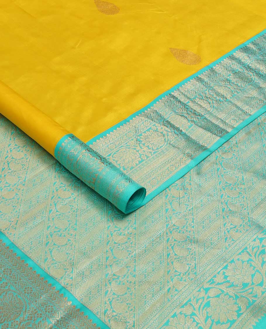 Yellow zari buttas silk saree, contrast border of jadai nagam, and mayil kann, and pallu of diagonally woven kodi manga and geometric designs