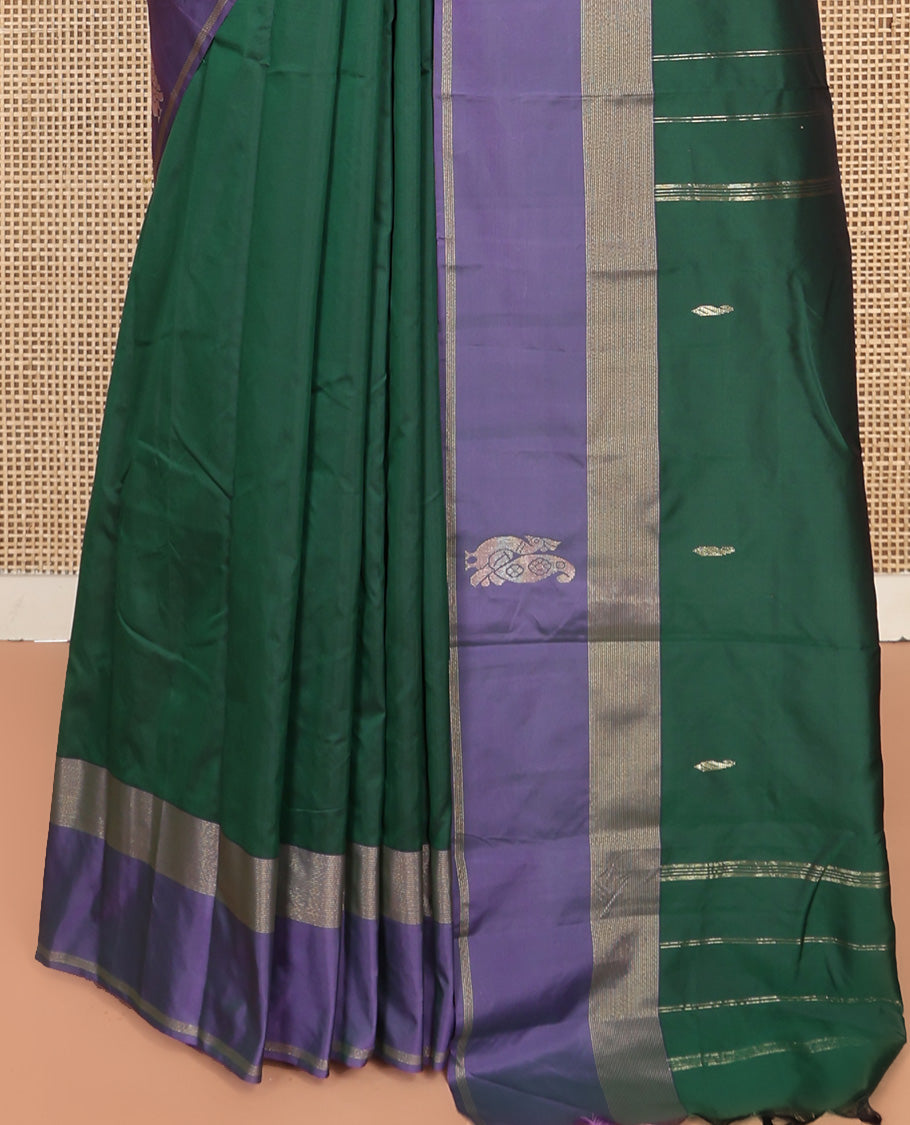 Green Aarani Silk Saree, Adorned with Zari Buttas All Over Its Body, Complemented by a Contrast Border of Peacock and Temple Border, Pallu of Zari Designs, and Paired with a Matching Blouse