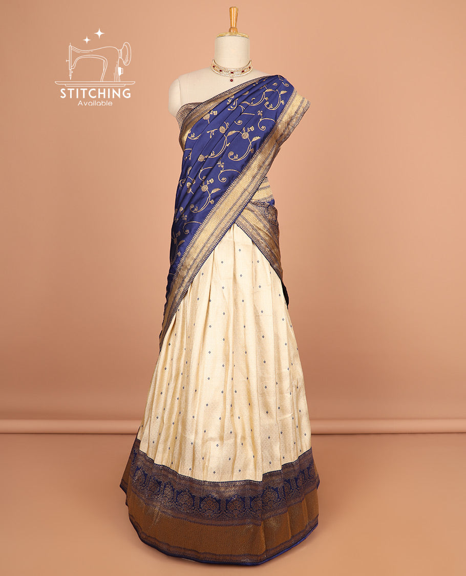 Cream buttas half saree with contrast zari design border, zari design blouse & floral vine zari design dhavani