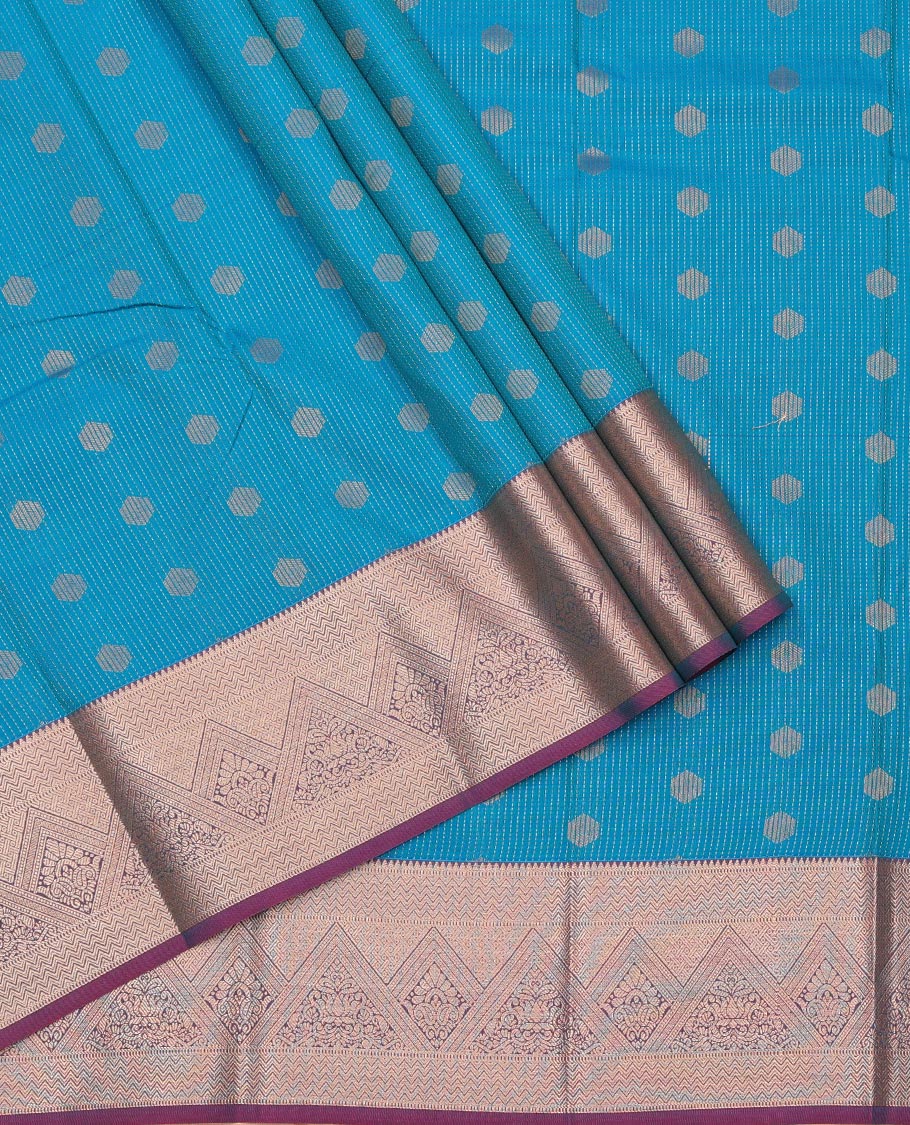 Blue Art Silk Pavadai Material Set, Subtly Enriched with Dotted Stripes and Buttas on Its Skirt, Complemented by a Contrast Traditional Zari Design Border, and Paired with a Contrast Blouse