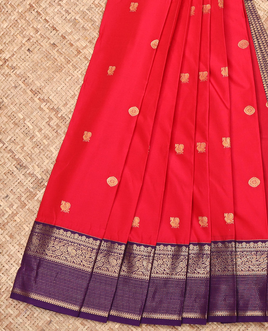 Red Budget Silk Saree, Highlighted by Peacock-Chakram Buttas All Over Its Body, Complemented by Contrast Traditional Zari Design Border, Grand Jaal Pallu, and Paired with a Contrast Blouse
