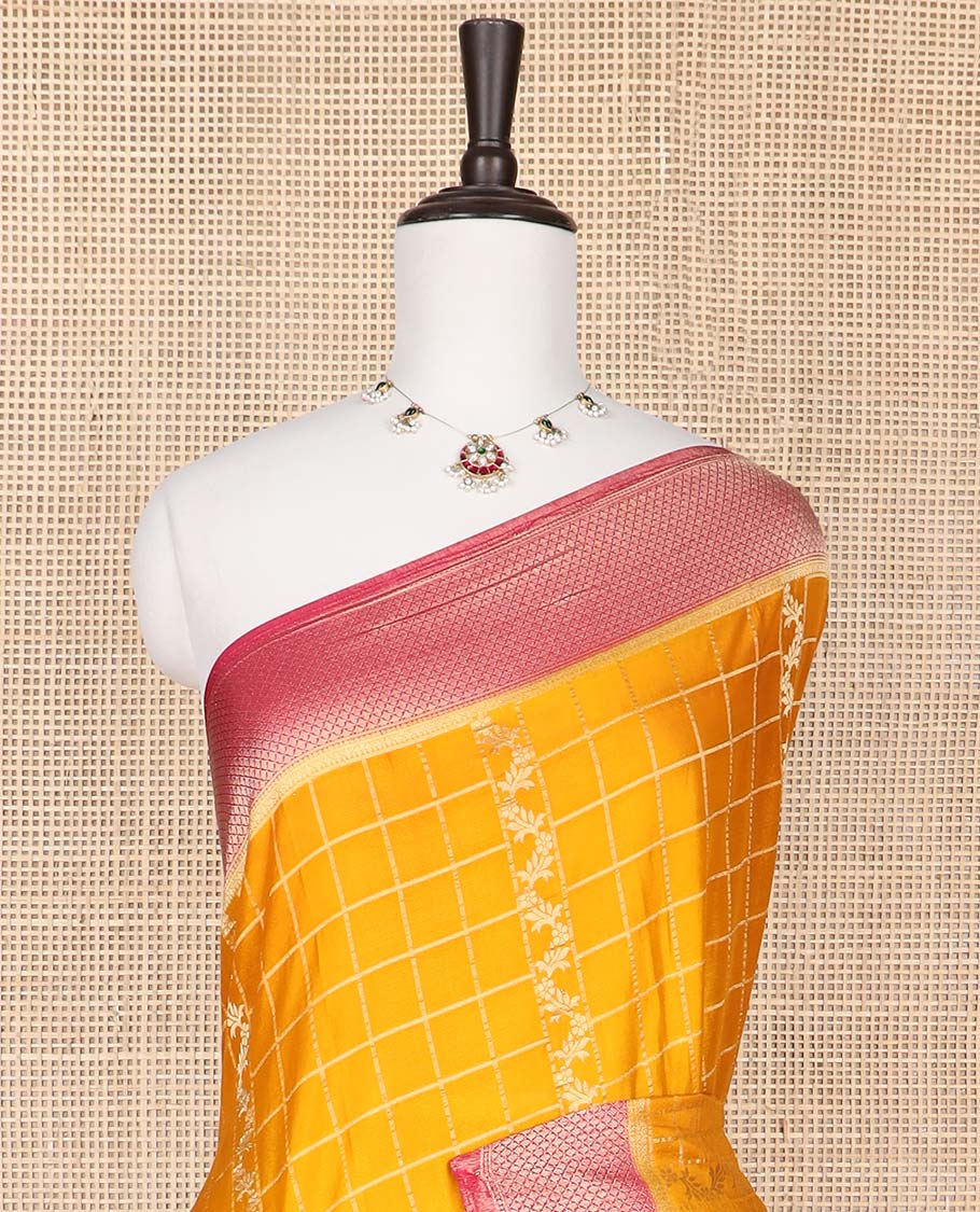 Orange checked fancy crepe saree with contrast checked border & floral design pallu