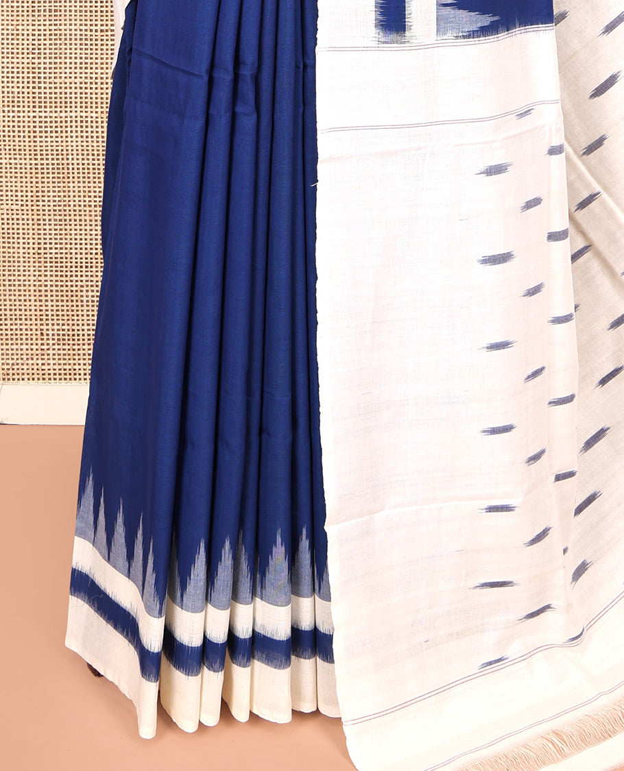 Navy Blue Plain Ikkat Cotton Saree, Complemented by a Contrast Ikkat Temple Border, Pallu Steeped with Buttas, and Paired with a Contrast Blouse