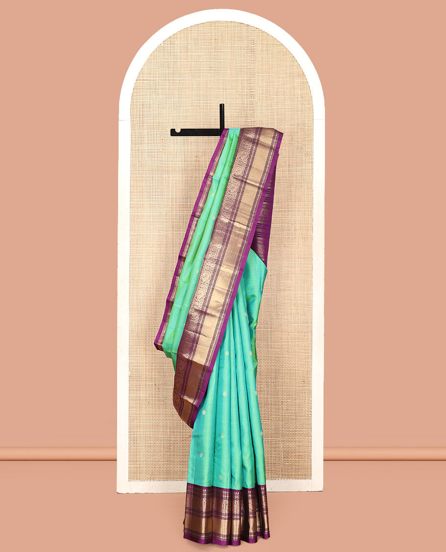 Rexona Green Vasundhara Silk Saree, Beautified with Sparse Stripes and Zari Buttas, Complemented by a Contrast Border of Thilakam, Banaras, Muthu, and Round Mayil Designs, Pallu Steeped with Traditional Designs, and Paired with a Contrast Blouse