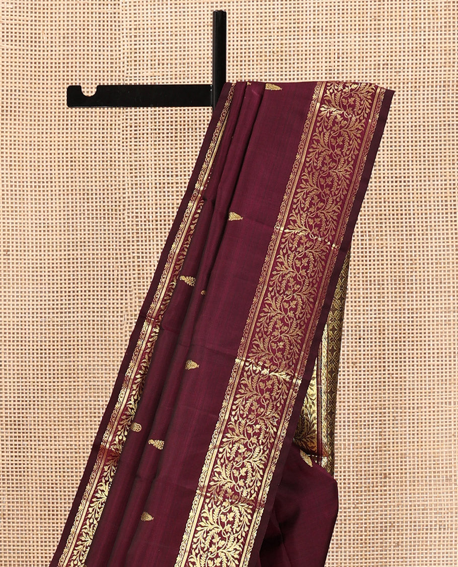 Wine Kanchipuram Silk Saree, Embellished with Zari Buttas on Its Body, Highlighted by a Zari Border of Floral Designs, Pallu of Jaal Designs, and Paired with a Matching Blouse
