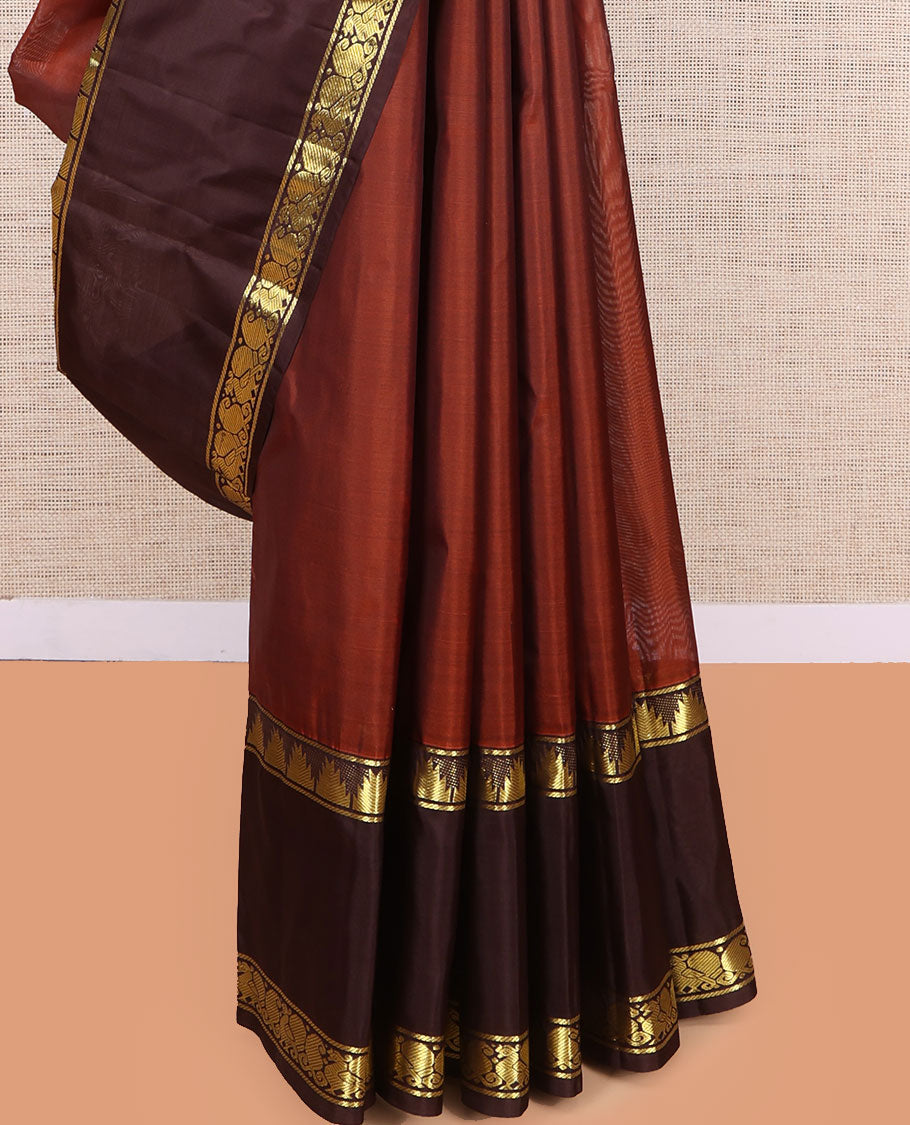 Dark Rust Plain Kanchipuram Silk Saree, a Contrast Rettai Pettu Border of Thazampoo Rekku, Mayil, and Maga Designs, Zari Striped Pallu, and a Contrast Blouse