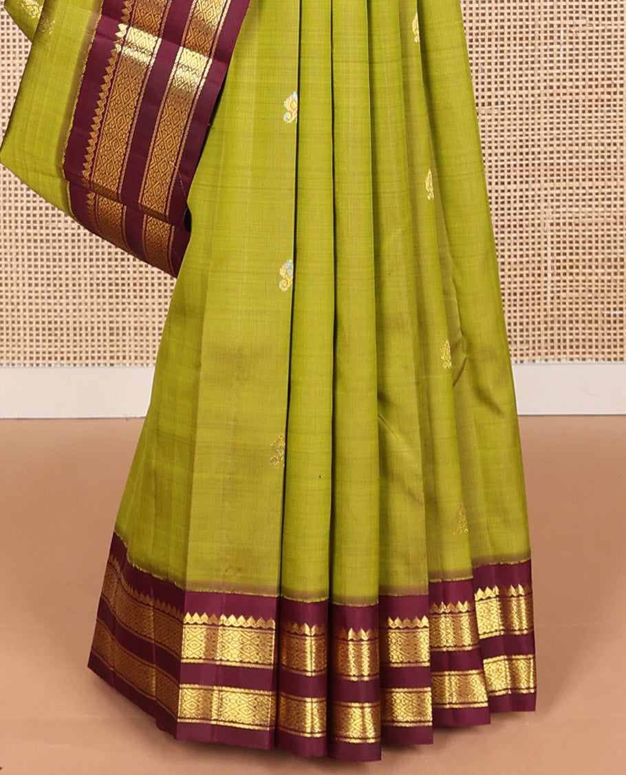 Green floral buttas kancheepuram silk saree with contrast korvai border of thilakam mokku, banaras, checked design & zari design pallu