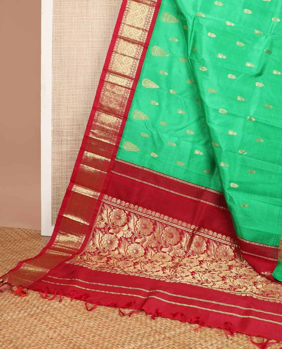 Green buttas kancheepuram silk saree with contrast korvai border of thilakam mokku, banaras design & floral pallu